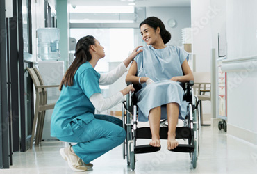 Doctor speaking with patient in wheel chair in a hospital