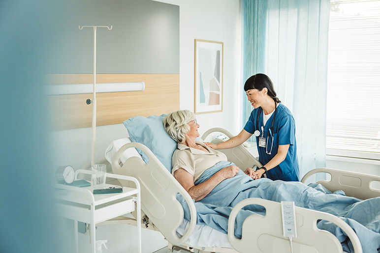 Senior woman in hospital bed.